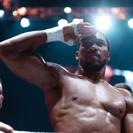Anthony Joshua wiping his brow in the ring